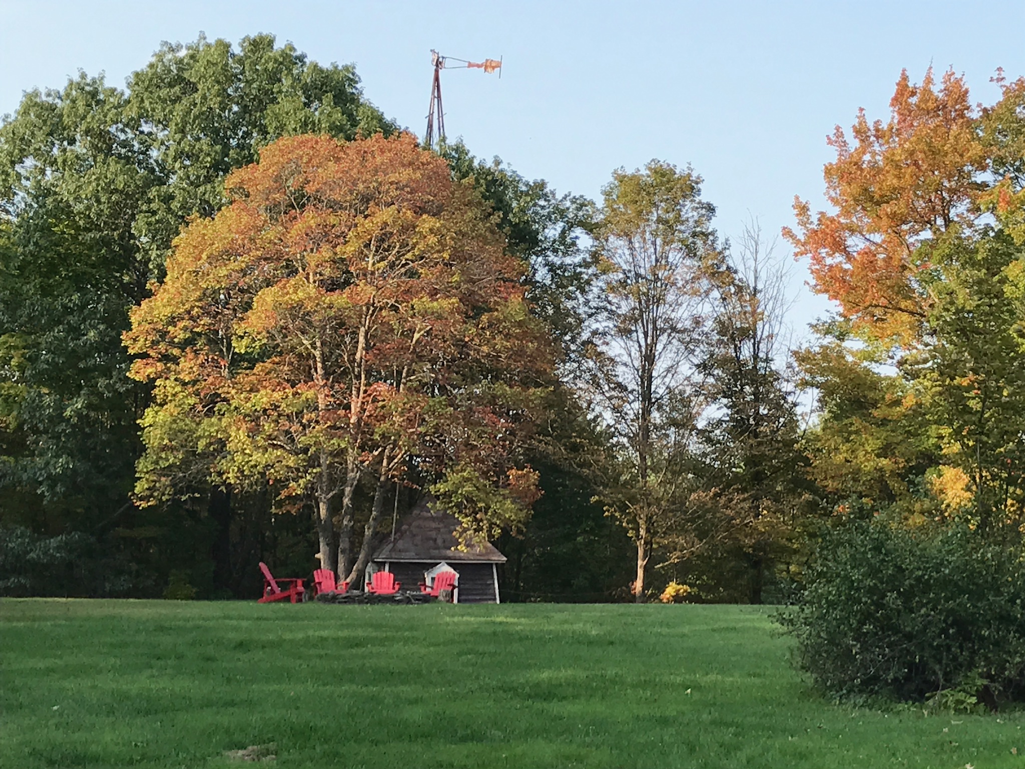 Autumn fire pit and windmill — peak foliage at Elliot Place
