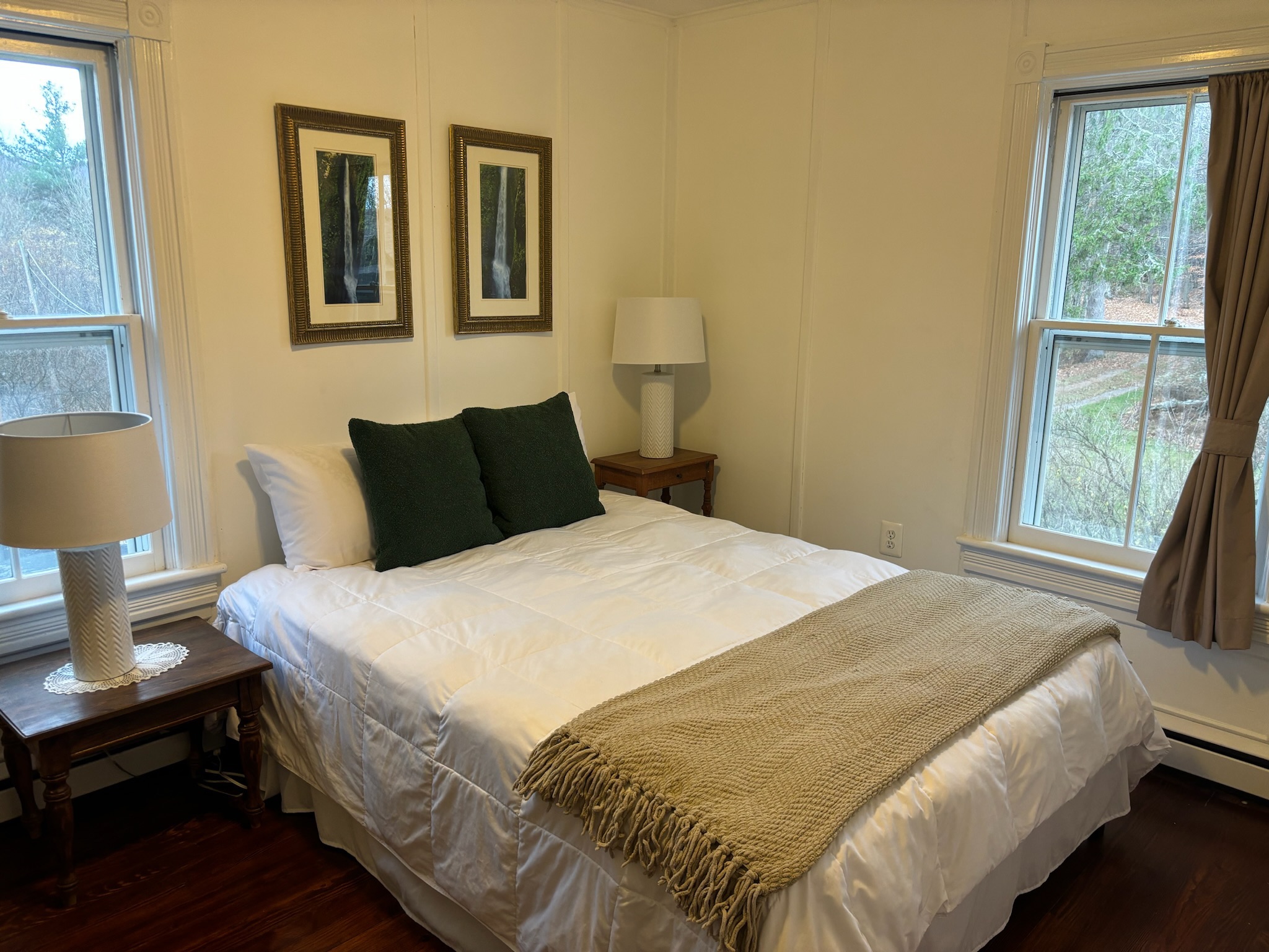 Queen bedroom — waterfall prints, antique dresser