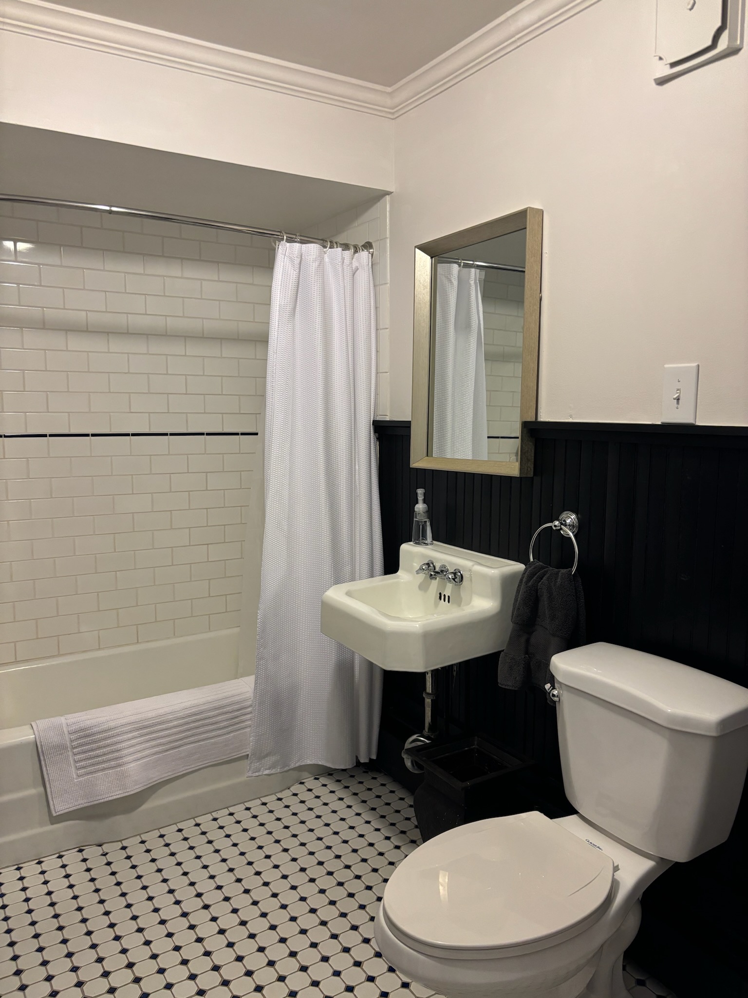 First floor bathroom detail showing antique fixtures and tile work