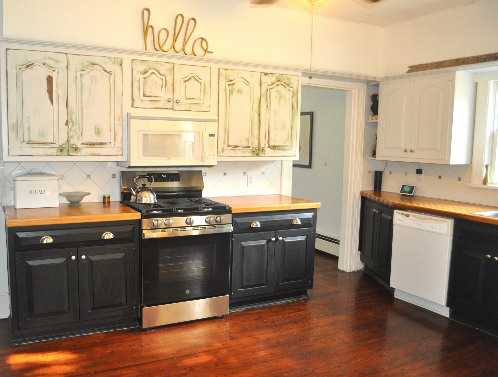 Kitchen from alternate angle showing full layout and hardwood floors