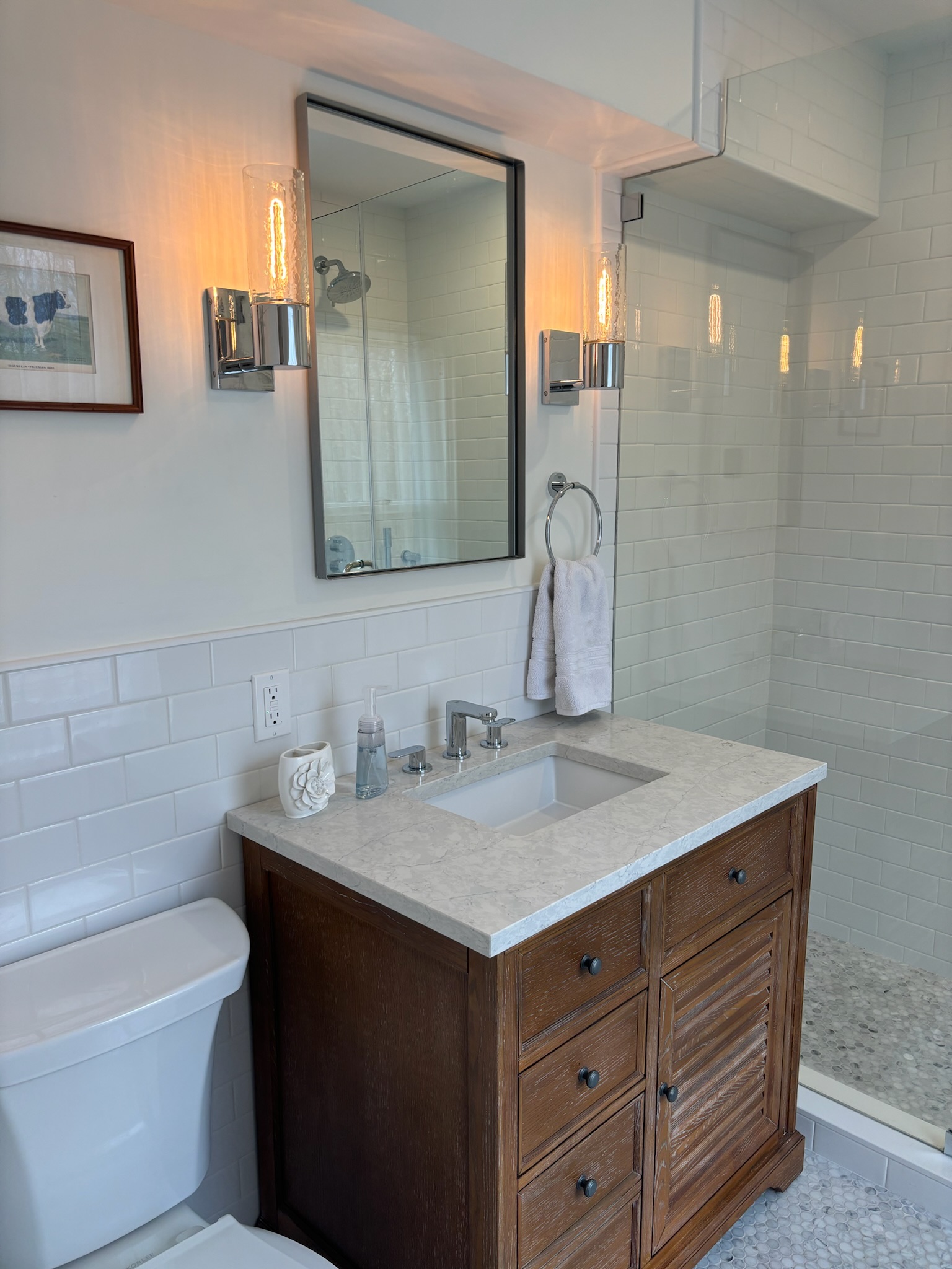 Second floor bathroom vanity detail with marble countertop and chrome fixtures