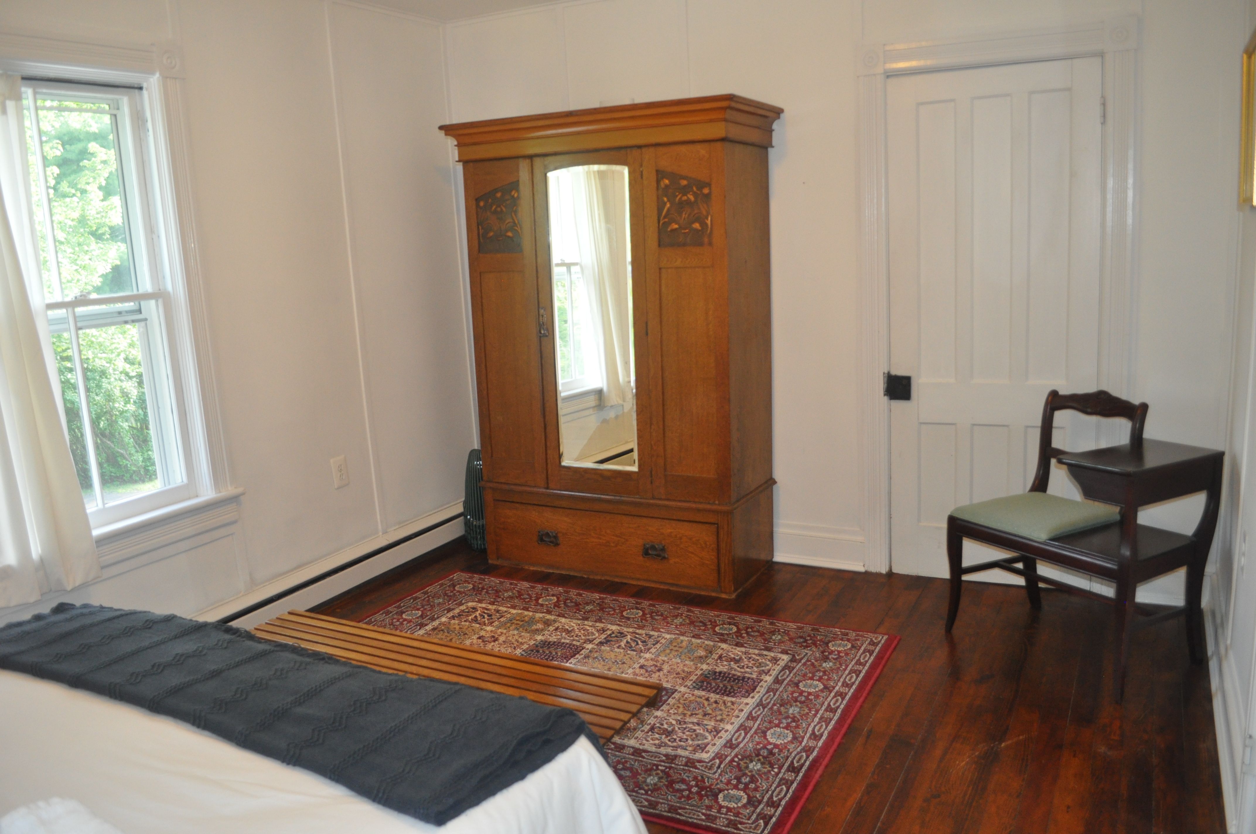 Bedroom two alternate angle showing antique wardrobe and original millwork details