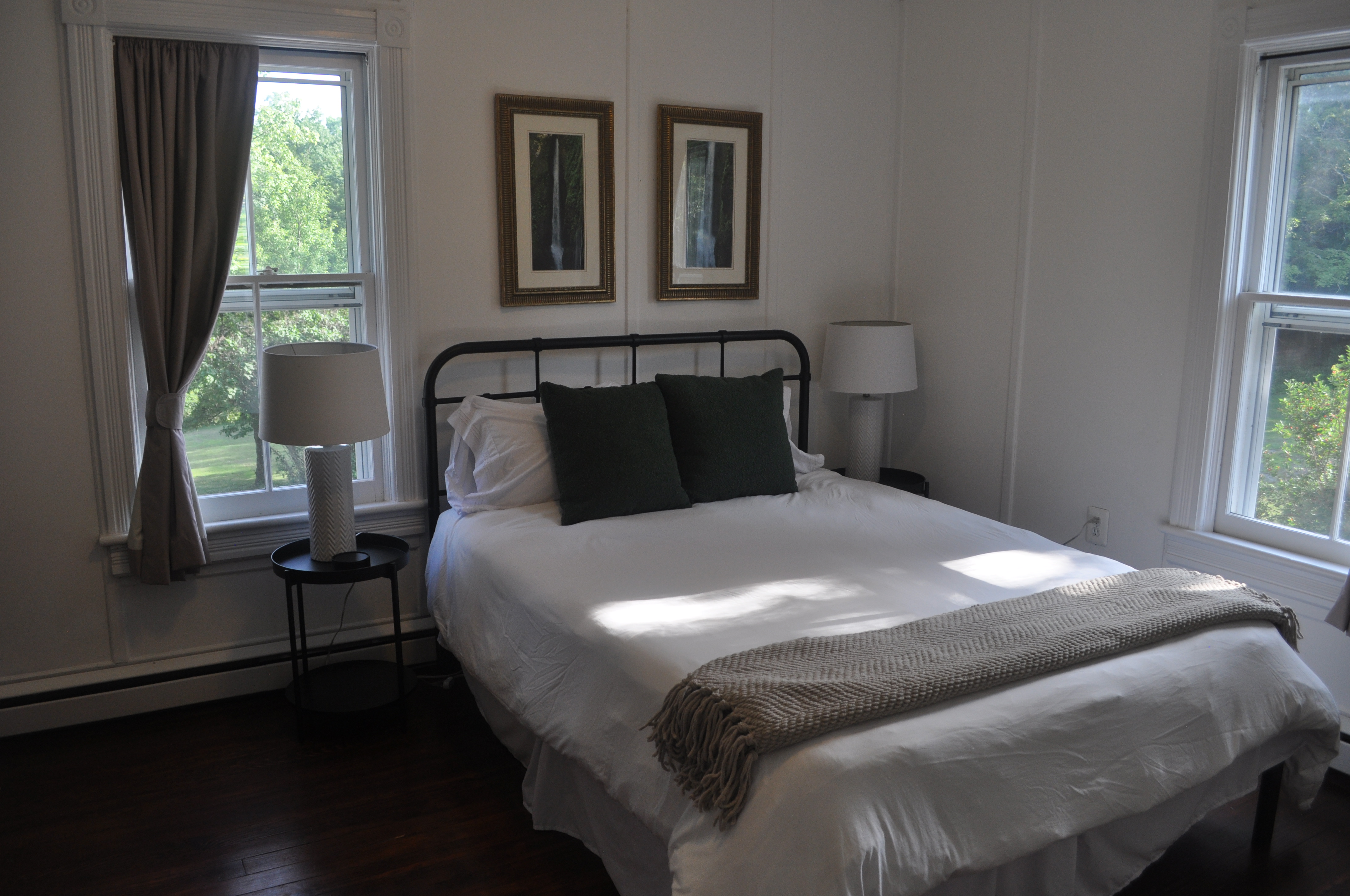 Bedroom three window detail with original millwork surround and forest view