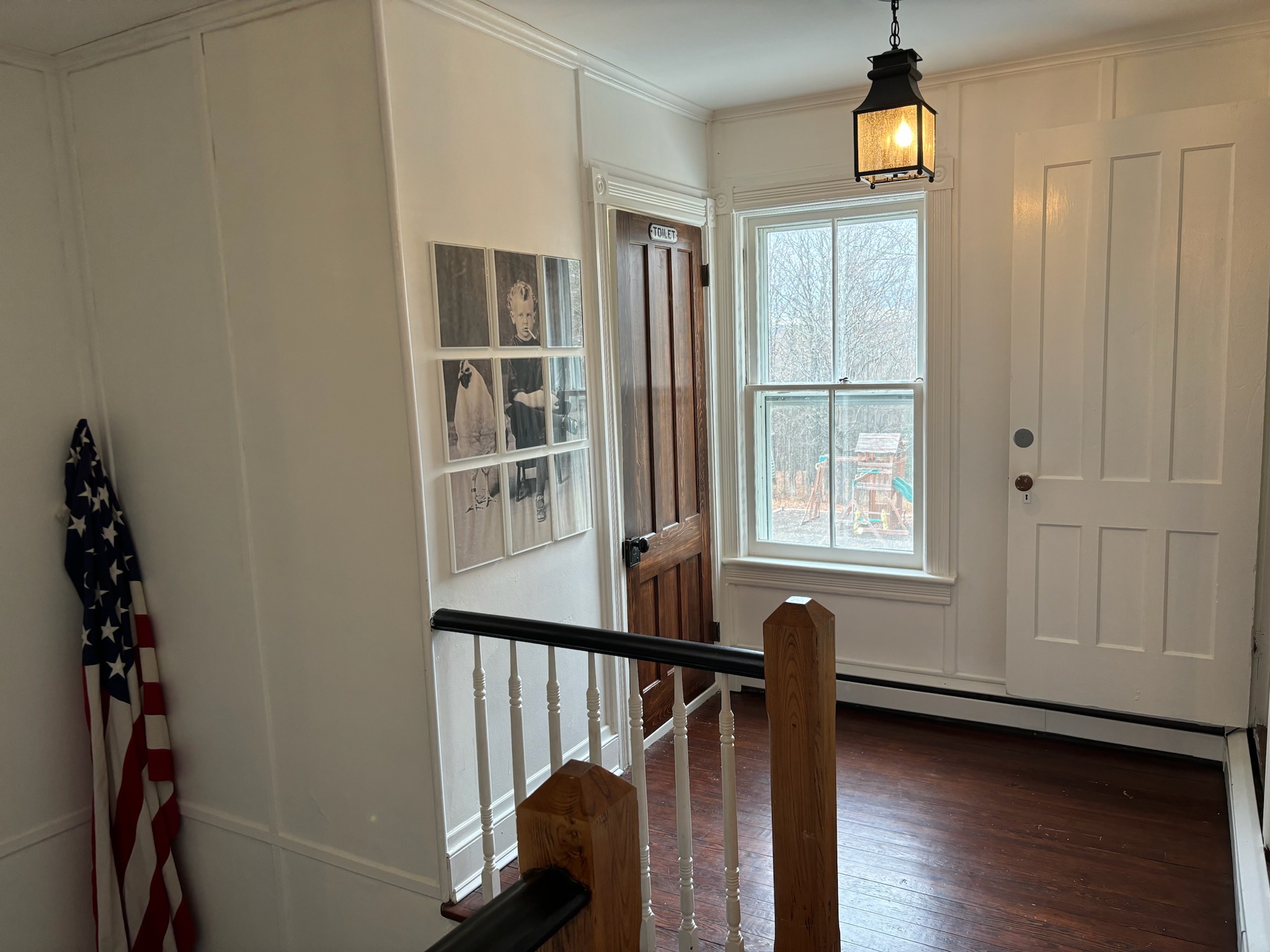 Second floor upper landing with lantern light and bedroom doorways