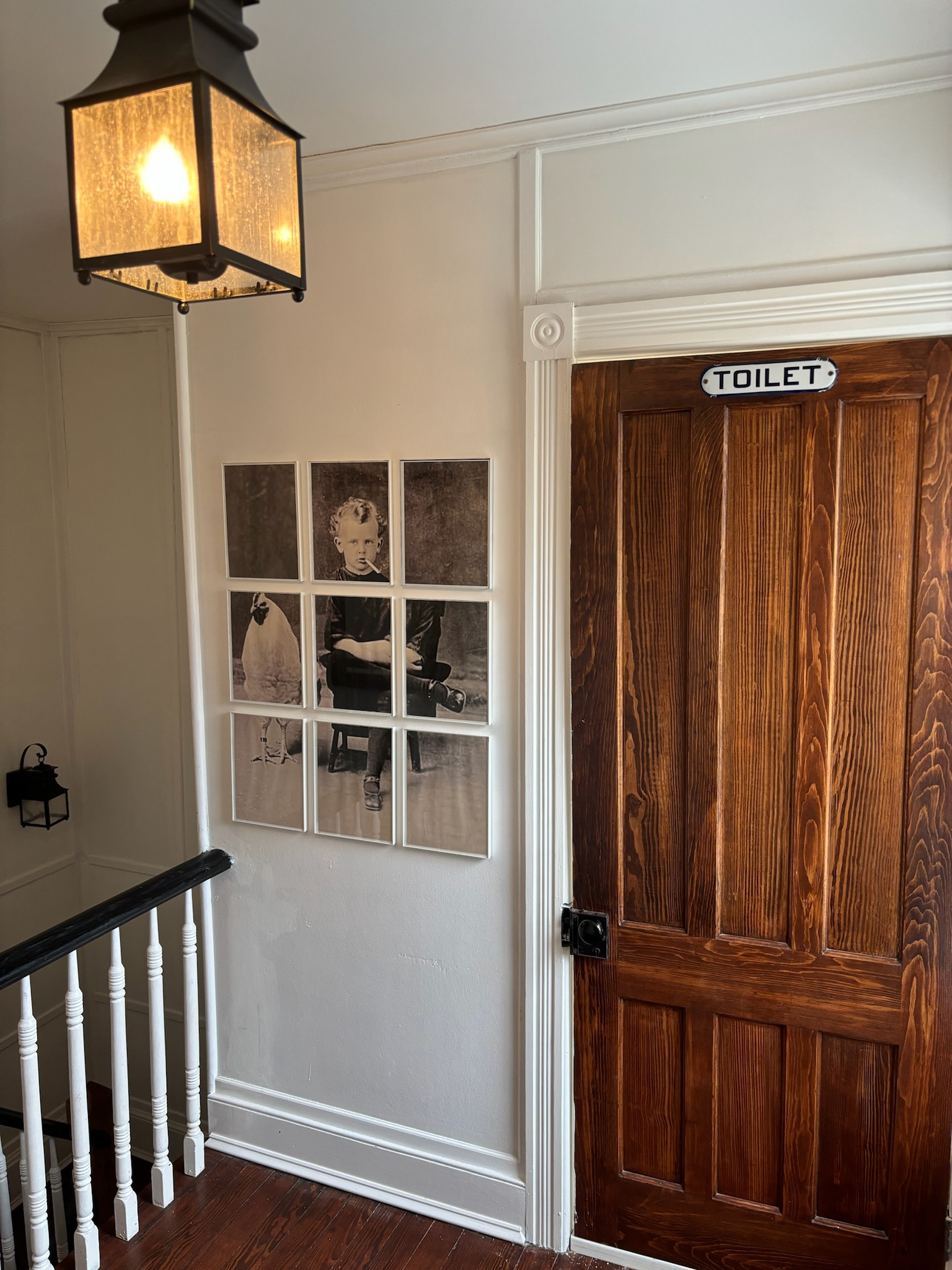 Second floor hallway view toward staircase with original millwork